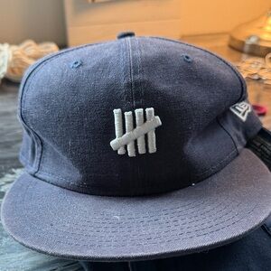 Undefeated navy flat brim White Logo